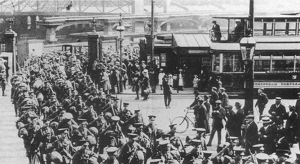 View of soldiers marching out of Queens Drive from New Street and crossing over Hill Street and into John Bright Street during the First World War