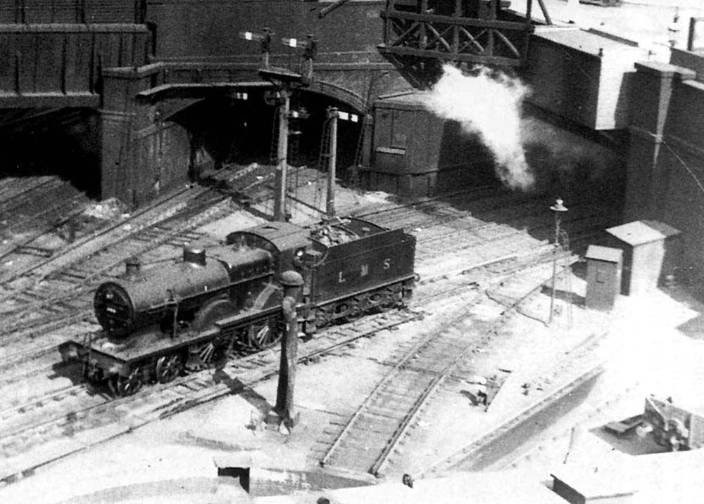 Close up showing an unidentified LMS 2P 4-4-0 standing on the down line leading from the Midland portion of the station