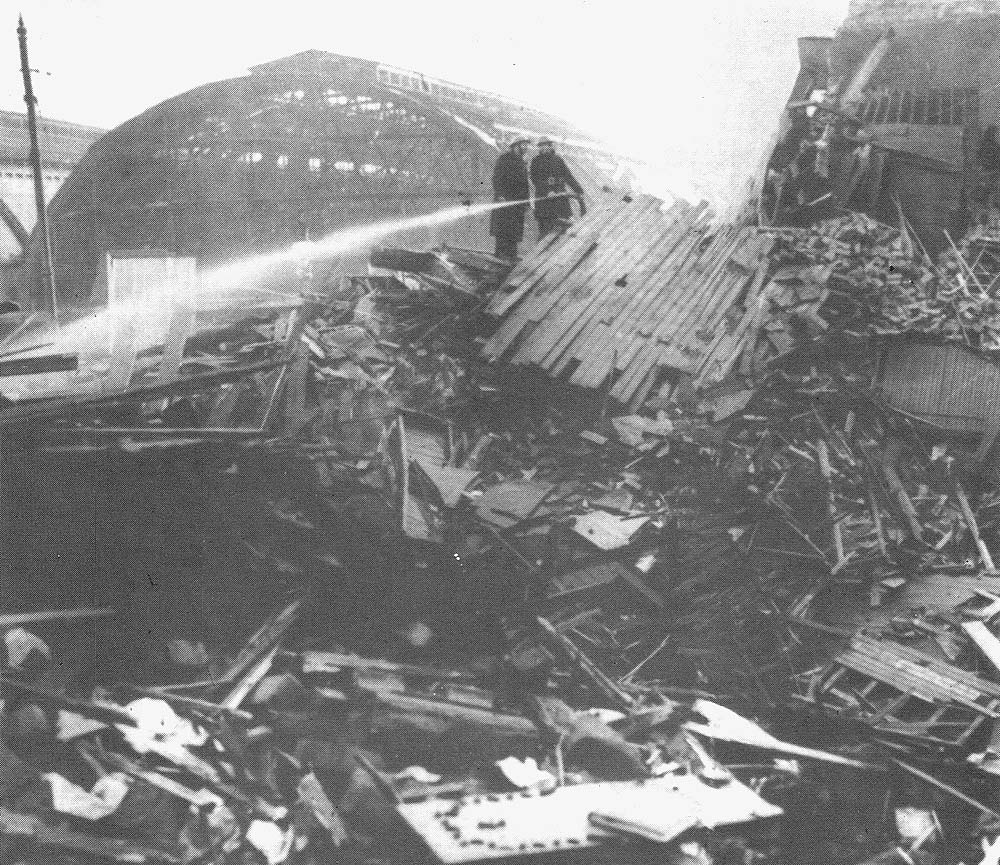 Fireman are still damping down the fire following the air raid which caused significant damage  to the LNWR side of the station