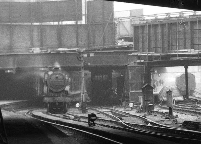 Close up showing the Stour Valley bay lines with an unidentified ex-LMS 2P 4-4-0 locomotive being held by the signal after coming off a local passenger train at Platform 2A