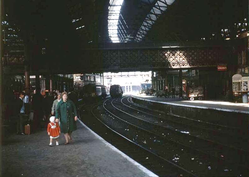 Looking along Platform 8 towards the West end of the station and New Street No 4 Signal Box as the sun streams through the roof on 1st August 1964