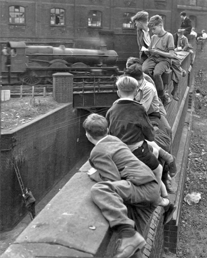 Trainspotters get the best of both worlds sitting on the wall at Paternoster Row Birmingham in 1952