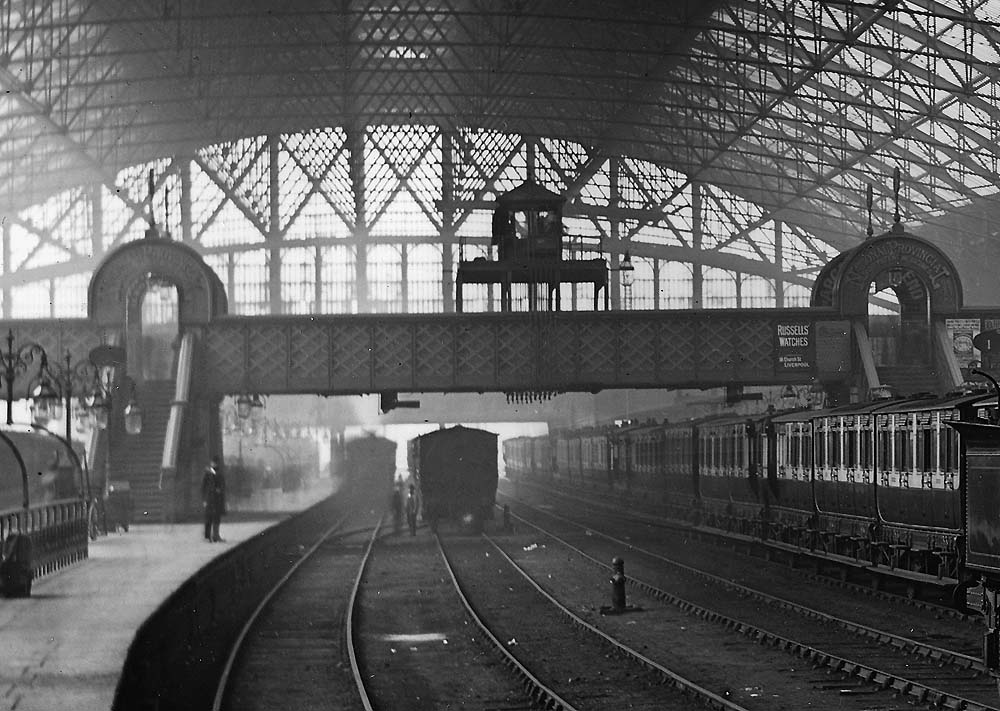 Close up showing New Street No 3 signal cabin and the signals controlling the passage of trains travelling towards the camera on the second and fourth tracks