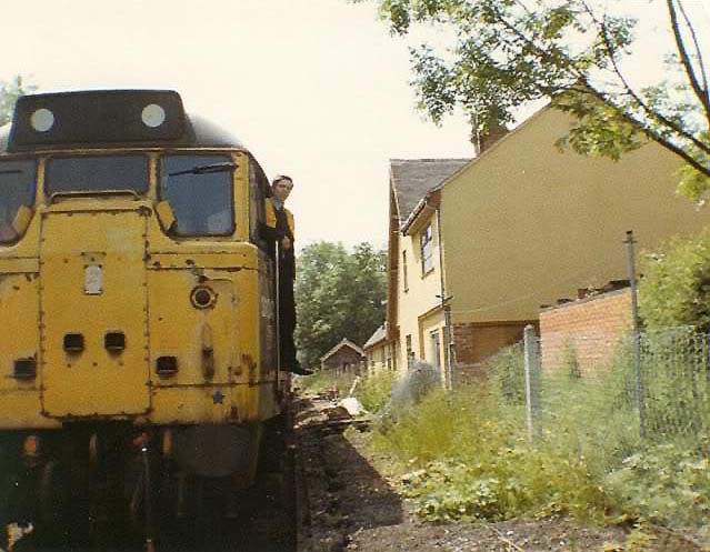 An unidentified Brush Type 2 A1A+A1A diesel locomotive pauses at the site of the abandoned Birdingbury station