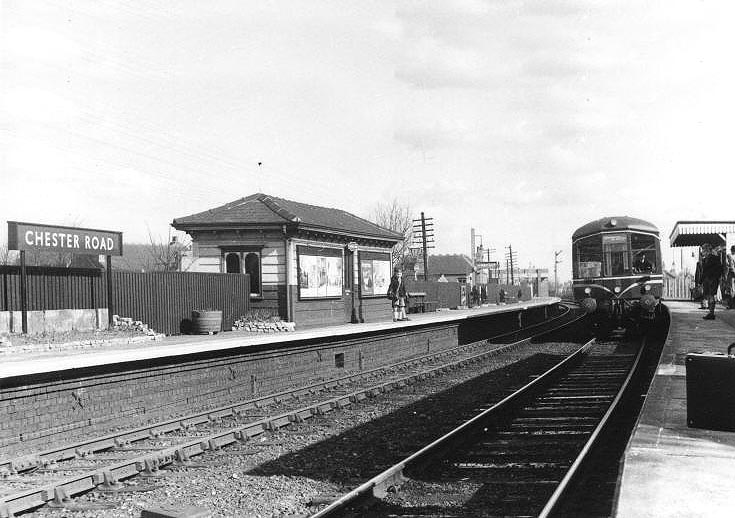 A DMU is seen arriving at the down platform whilst at the head of a Lichfield to Birmingham New Street service in 1956