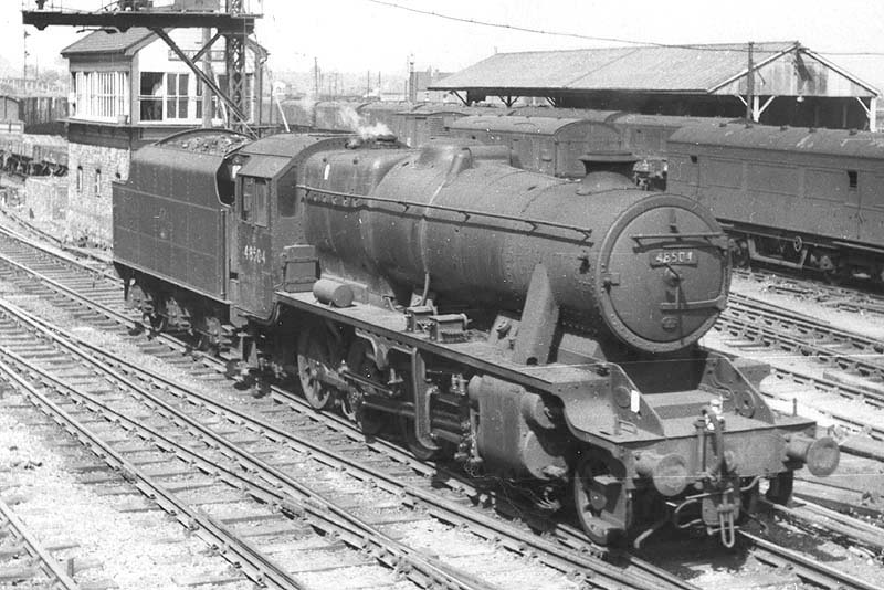 Ex-LMS 8F 2-8-0 No 48504 restarts from the signals by Coventry no 3 Signal box as it runs light engine through Coventry station