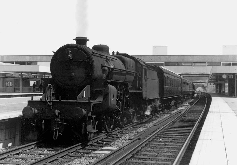 Ex-LMS 2-6-0 'Crab' No 42940 is seen standing at Coventry station's platform three at the head of a Rugby to Birmingham service