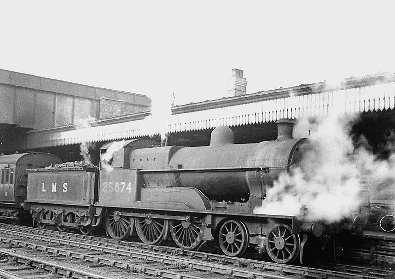 Ex-LNWR 4-6-0 POW class No 25674 'Scott' is seen at the head of a local Rugby to Birmingham passenger service entering Coventry station's down platform