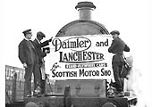 Workmen from Daimler and Lanchester Cars and the LMS attach a poster to the smokebox of the ex-LNWR 4-6-0 locomotive