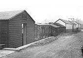View showing a variety of timber-framed and clad huts and an old carriage used as mess and storage facilities in Warwick Road goods yard