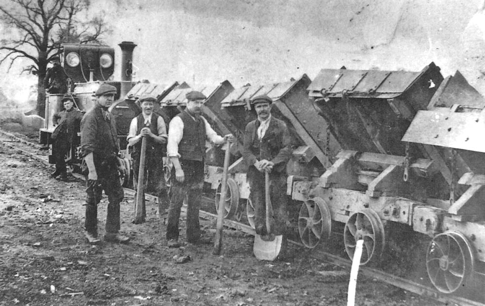 A gang of labourers pose for the camera alongside the contractor's narrow gauge railway used to move spoil from the earthworks