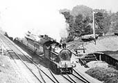 Close up showing the unidentified LNWR 4-4-0 George Fifth class locomotive as it passes over the junction with the loop line