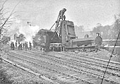 View across the junction showing the rear of the unidentified locomotive's tender being hoisted into the air