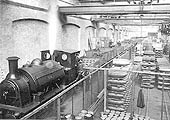 View of inside the Shell Shop at White & Poppe's factory in Holbrooks as workers are seen loading shell cases into wagons ready to be transported to be filled with explosive