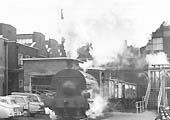 Peckett 0-4-0ST Works No 1722 'Rocket' is seen working a train of coal wagons through Courtaulds factory in March 1969