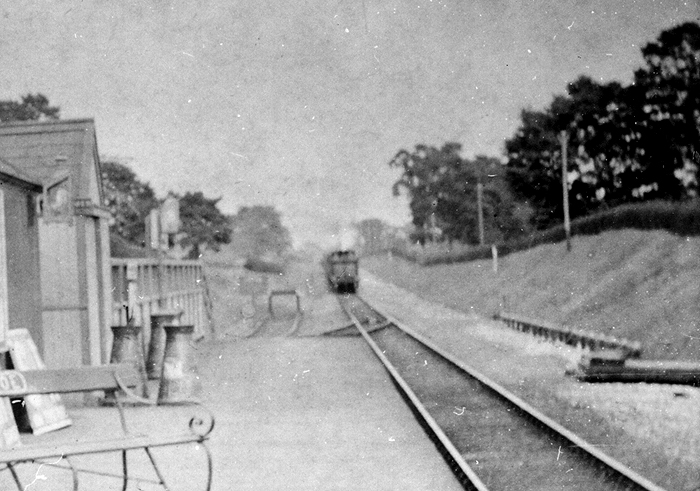Close up of an unidentified LNWR 0-6-0 locomotive running tender first approaching the station with a Weeden to Warwick Milverton service