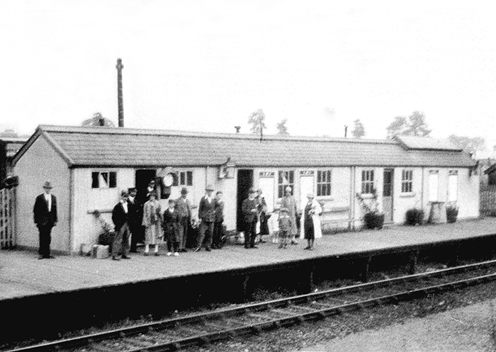 A post Second World War view of Flecknoe station complete with passengers and luggage standing on the platform