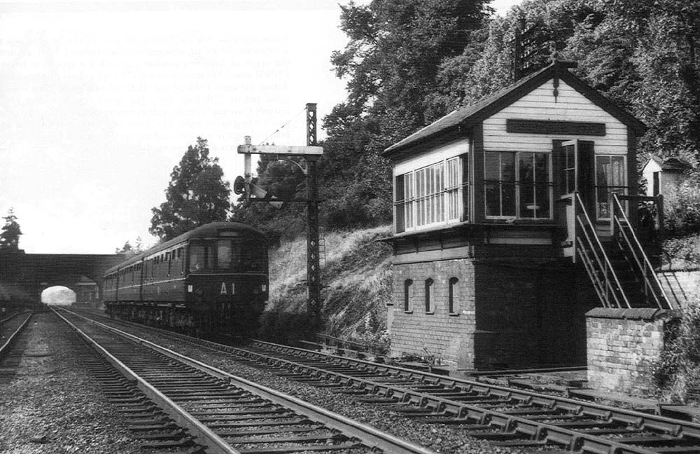 The lower quadrant  signal gives right of way to a Metro-Cammell 3 Car DMU to pass Hampton in Arden Signal Cabin on 27th June 1961