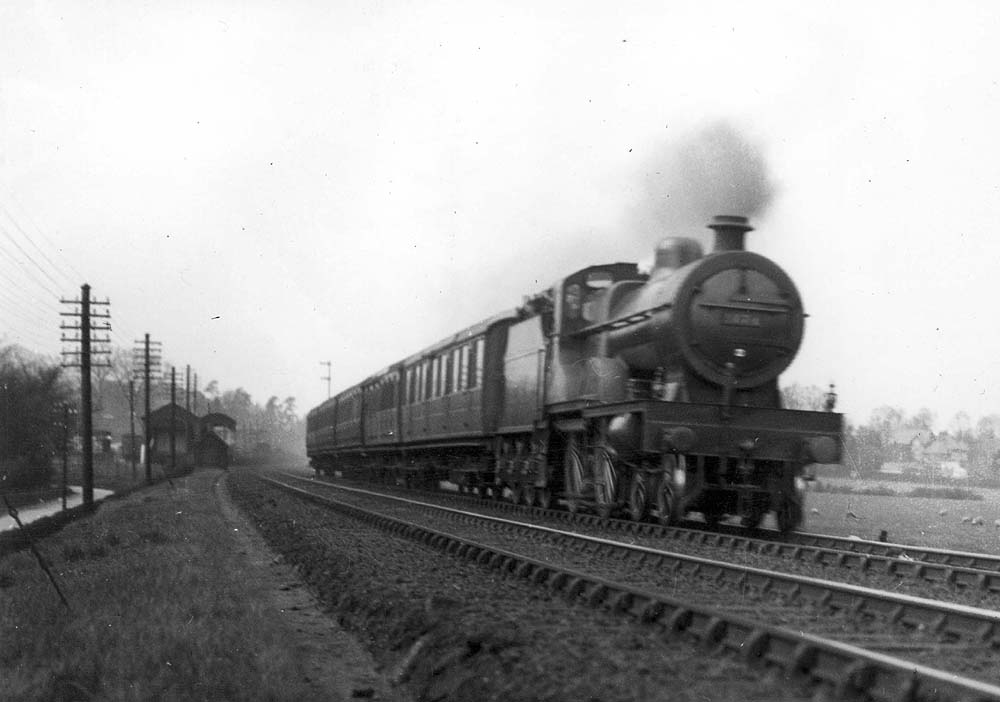 LMS 4P 4-4-0 Compound No 1076 is seen at the head of an up express train just to the south of Hampton in Arden goods yard circa 1930s