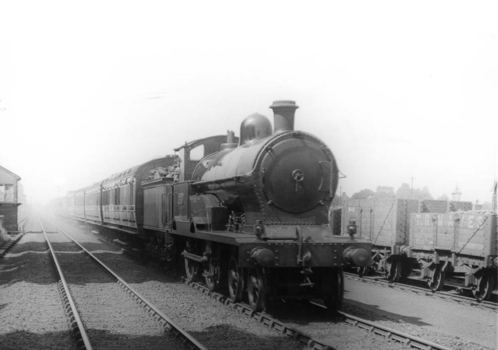 LNWR 3P 4-4-0 George V class No 226 'Colwyn Bay' is seen passing Hampton Junction signal box on an up two-hour express in July 1921