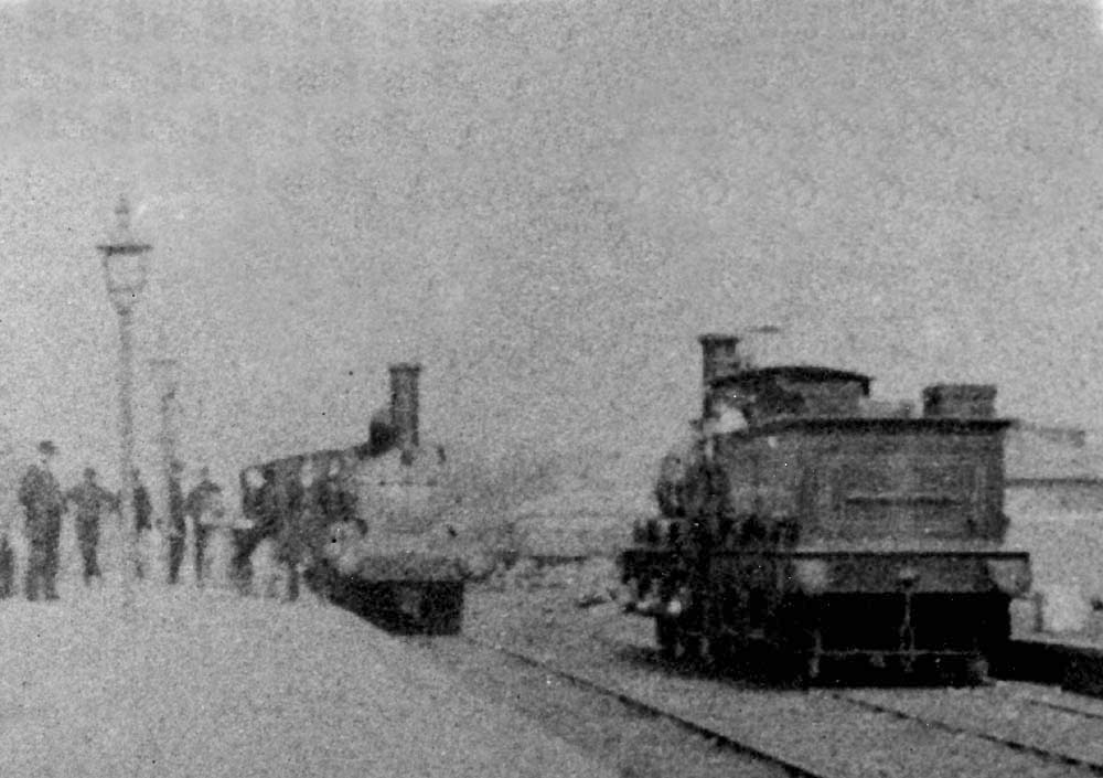 View of LNWR locomotive standing in the Midland portion of the station on a southbound service opposite a MR Kirtley 0-6-0