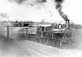  LNWR 2-4-2T No 1155 is seen passing under the footbridge at the head of a train to New Street station circa 1900