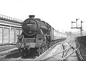 Ex-LMS 5MT 4-6-0 No 45437 is seen on the down mail line with an empty carriage working on 4th July 1955