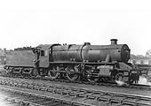 LMS 2-6-0 5MT No 2973 is seen in steam with the driver climbing aboard to move it off shed for its next turn of duty