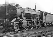 Ex-LMS 2-8-0 8F No 48258 is seen coupled to a Fowler 3500 gallon tender having just been coaled and watered and stands alongside the shed
