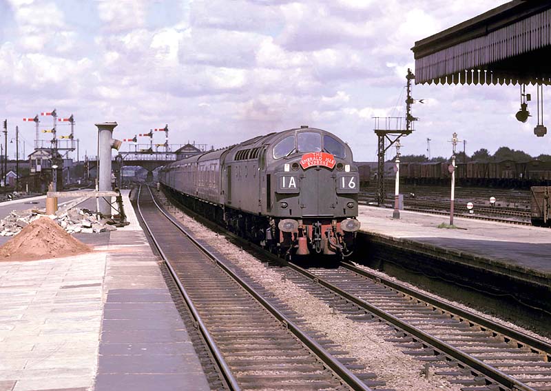 An unidentified English Electric Type 4 Diesel locomotive passes through with the up 'Emerald Isle Express'