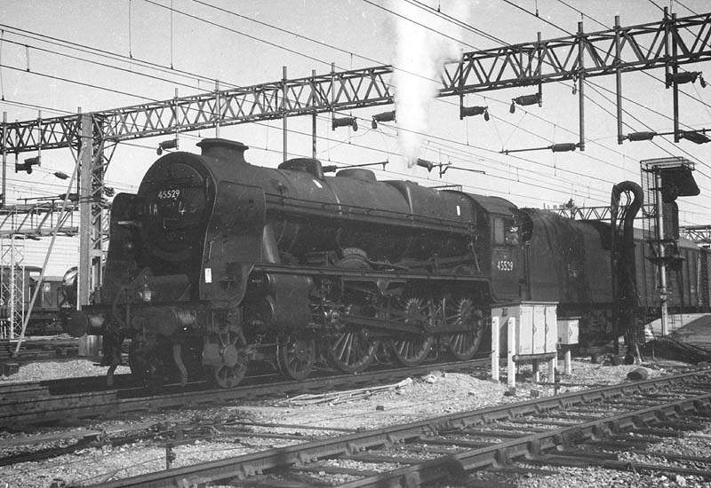 Ex-LMS 4-6-0 Rebuilt Patriot class No 45529 'Stephenson' is seen standing under the wires on a down express freight