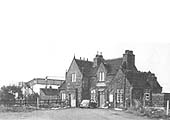A late British Railways view of the outside of the station after electrification showing the station master's house separated by a fence