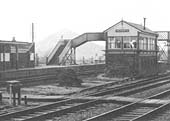 Close up showing Polesworth station's replacement signal box with passenger footbridge behind and barrow crossing in front