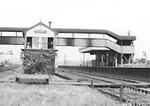 Close up of Polesworth's 1909 LNWR Signal Box and the two signal gantries controlling the down slow line on the left with the down fast to its right