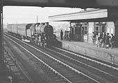 An unidentified ex-LMS Ivatt 2-6-0 4F locomotive heads a three-coach local stopping service into Polesworth circa 1949