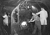 View of the crew working inside the cab of Bullied Pacific No 35022 'Holland America Line' in March 1953