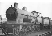 Ex-LNWR Precursor class 4-4-0 No 25187 'Helvellyn' stands outside No 1 shed on the inspection pit roads circa 1935