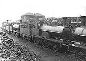 Ex-LNWR 2-4-0 Precedent Class 5000 'Princess Beatrice' stands in a row of other stored locomotives circa 1932