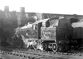 Ex-LMS 4P 2-6-4T No 42446 stands wreathed in smoke outside of Rugby's No 2 shed with Joe Brown in the cab