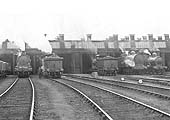 Close up of two unidentified LNWR 4-4-0 George Fifth locomotives being prepared to leave the shed