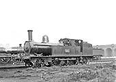 LNWR 5 foot 6 inch 2-4-2T No 697 stands in front of Rugby's No 1 shed waiting to be disposed of after coaling and watering