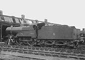 Ex-MR 2P 4-4-0 No 40487 stands with an unknown cleaner  outside of Rugby No 2 shed in Spring 1959