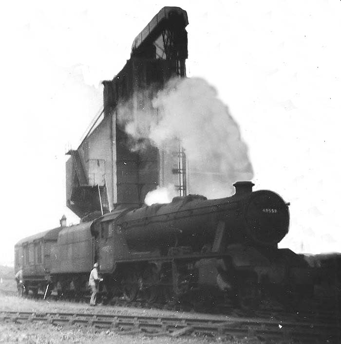 Ex-LMS 8F 2-8-0 No 48559 pauses briefly after bringing the stores van onto rugby shed in Spring 1959