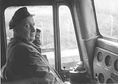 An unidentified diesel driver poses for the camera inside the cab of his Sultzer locomotive during a brief pause in his duties
