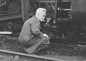 Close up showing the head fitter assessing how best to re-rail the locomotive with the minimum of fuss
