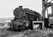 Close up of ex-LMS 2-8-0 8F No 48173 is seen standing alongside Rugby shed's ash plant on 19th July 1964