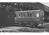 Departmental six-wheel saloon No DM284672, now being used for mess purposes, stands half inside Rugby shed
