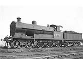 Ex-LNWR 4-6-0 No 25701 is seen in steam and coaled and watered on the approach road near the coaling stage