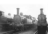 Ex-LNWR 1P 2-4-2T No 6749 stands alongside ex-LNWR 0-8-0 No 9261 and others in front of No 1 shed on 24th May 1936