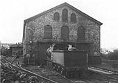 View of the entrance to the three road engine repair workshop with the stationary boiler on the left